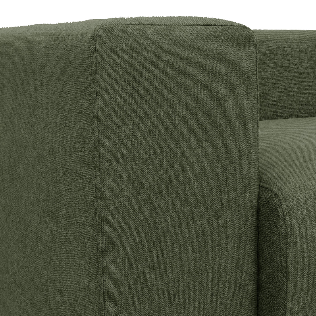 Close-up of green sofa armrest and backrest on white background