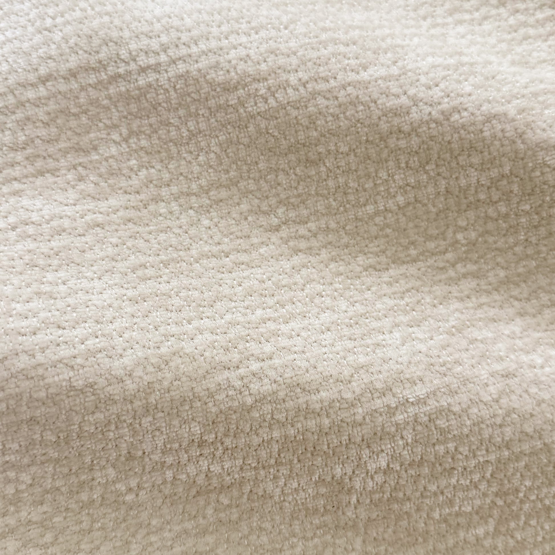 Close-up of beige textured upholstery fabric