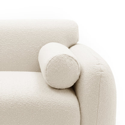 Close-up of sofa armrest and bolster pillow