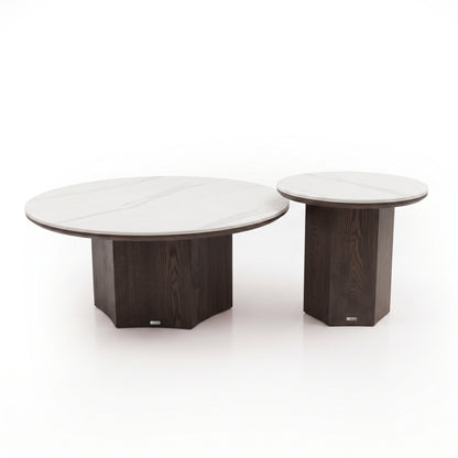Two round tables with light tops and dark wooden bases on a white background