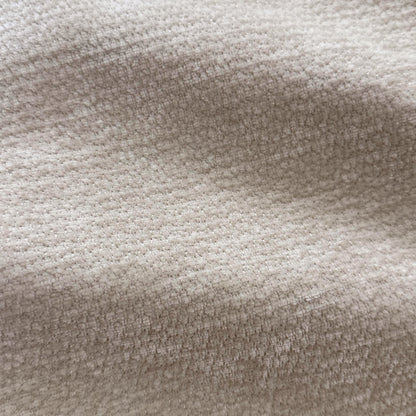 Close-up of beige woven fabric texture