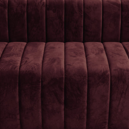 Close-up of burgundy upholstered furniture fabric and tufting