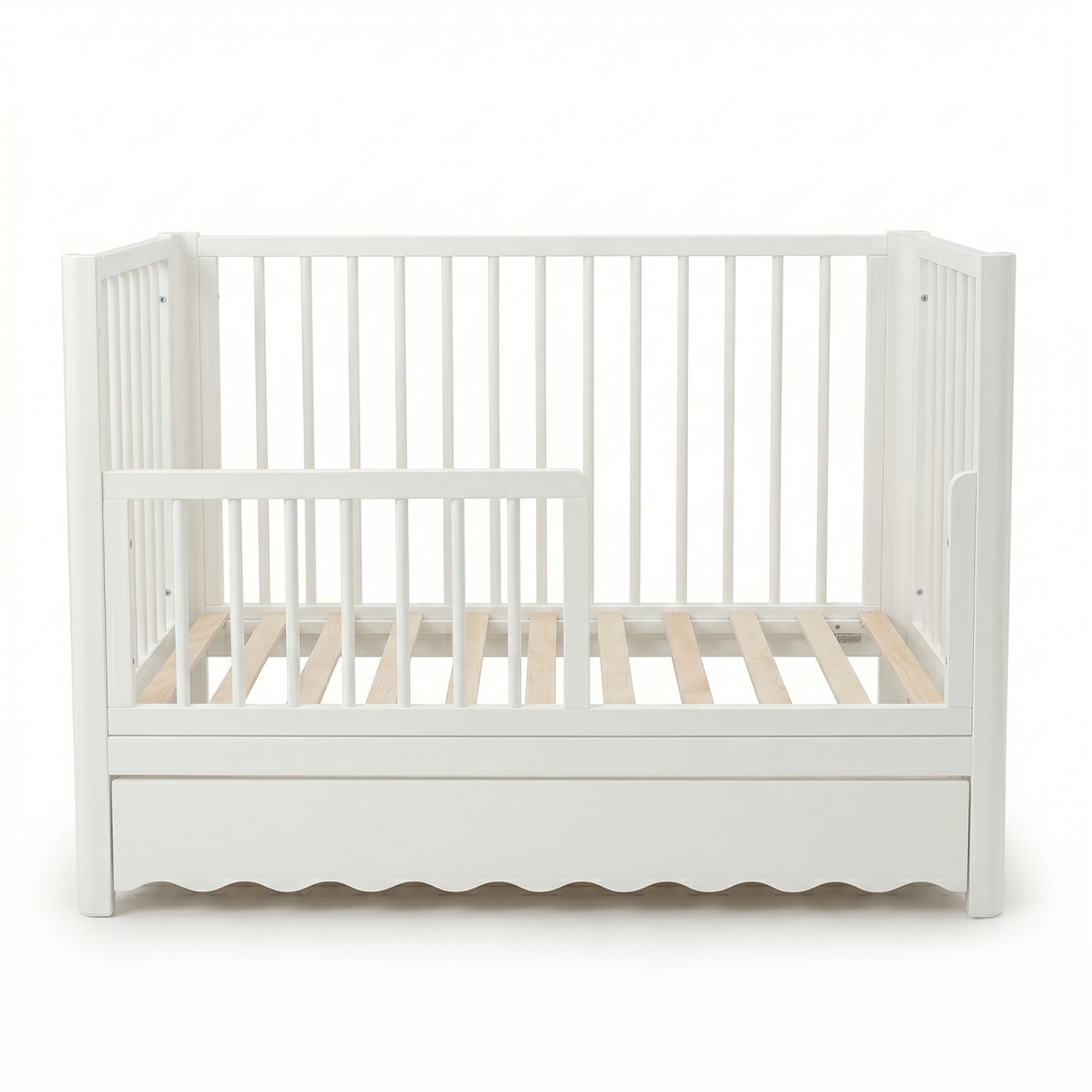White toddler crib with underbed drawer on white background