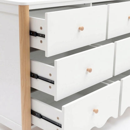 Close-up side view of white dresser drawers and metal sliding mechanism on white background