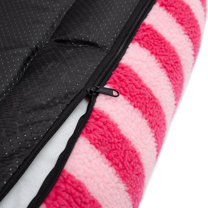 Extreme close-up of pink striped plush fabric and black zipper seam on a white background