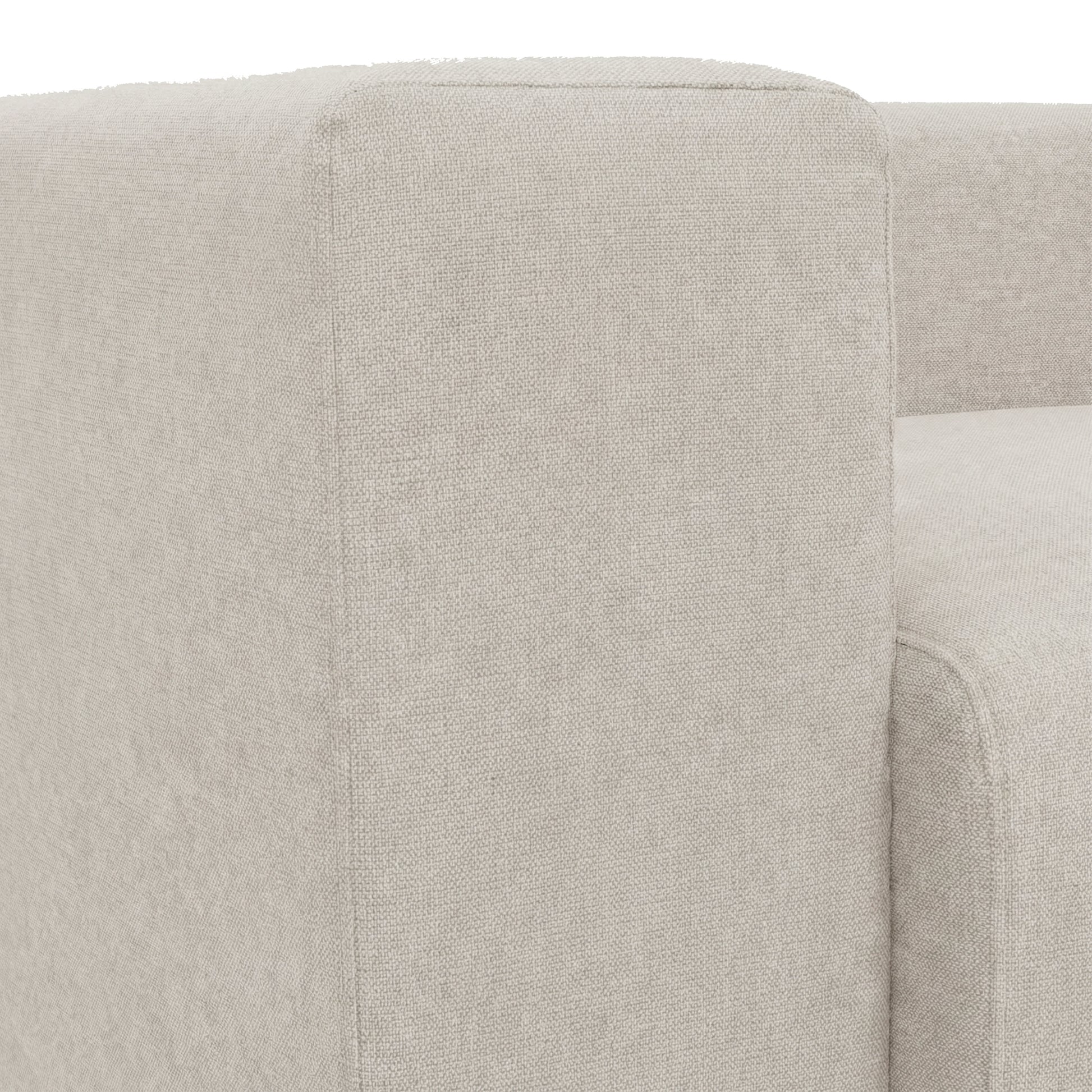 Close-up armrest and seat of beige sofa on white background