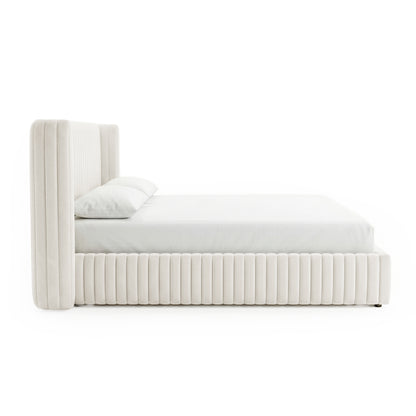Side profile of upholstered bed on white background