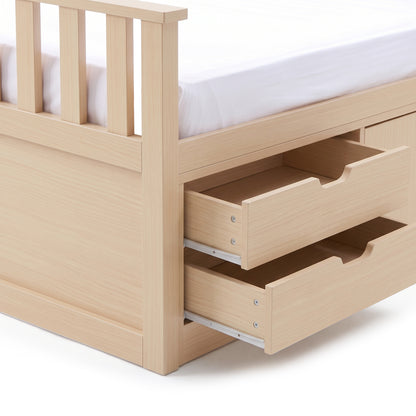 Close-up of wooden bed frame corner with open storage drawers on a white background