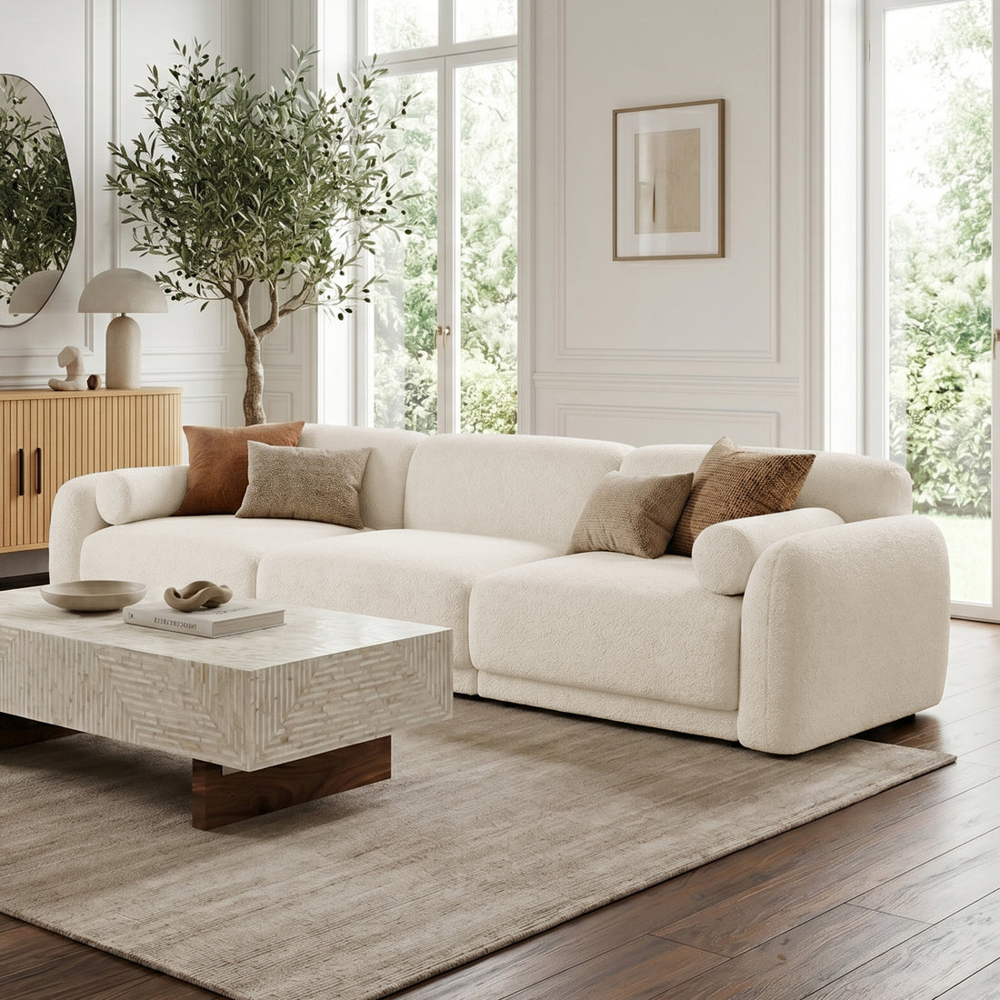 Large off-white sectional sofa in styled living room with neutral decor and natural light