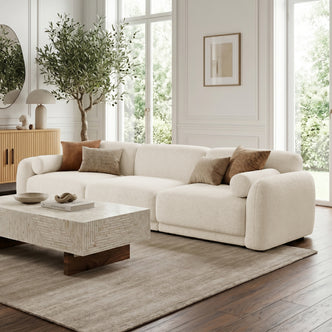 Large off-white sectional sofa in styled living room with neutral decor and natural light