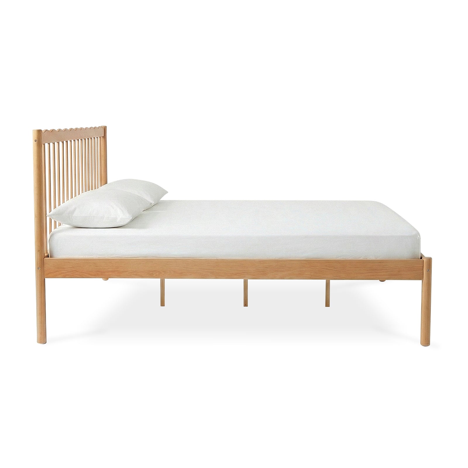 Side view of modern wooden bed frame with white mattress on white background