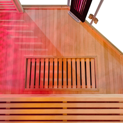 Close-up of a wooden sauna interior section with a bench, vent, and heater glow.