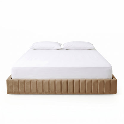 Beige upholstered bed with white bedding and pillows on white background