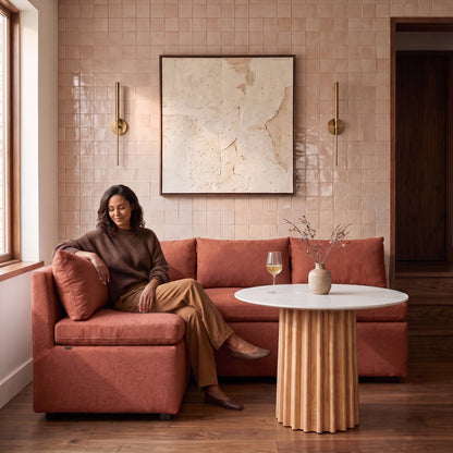 Terracotta sectional sofa with a person relaxing in a stylish living room