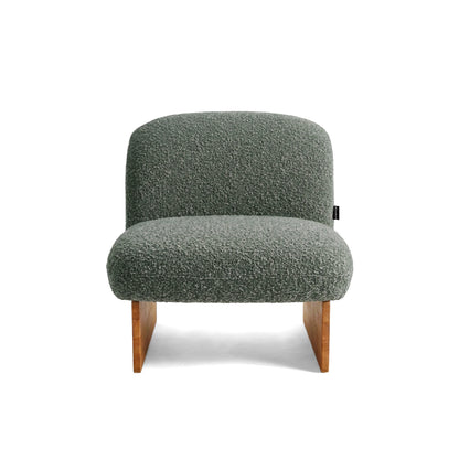 Front view of green accent chair on white background