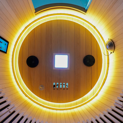 Sauna interior ceiling detail with circular lighting and wood panels