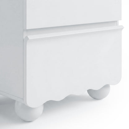 Close-up of scalloped lower edge and ball foot of white cabinet
