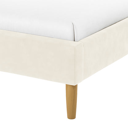 Estilla Velvet Rainbow Bed in Beige features a light-cream upholstered corner with a white mattress and a tapered wooden leg, embodying cosy velvet charm and sturdy support.