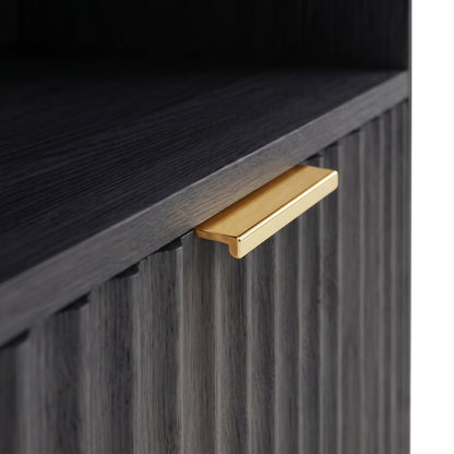 Close-up of textured black cabinet front with a gold handle
