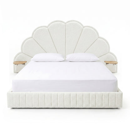 Modern scallop-shaped upholstered bed with integrated side tables on white background