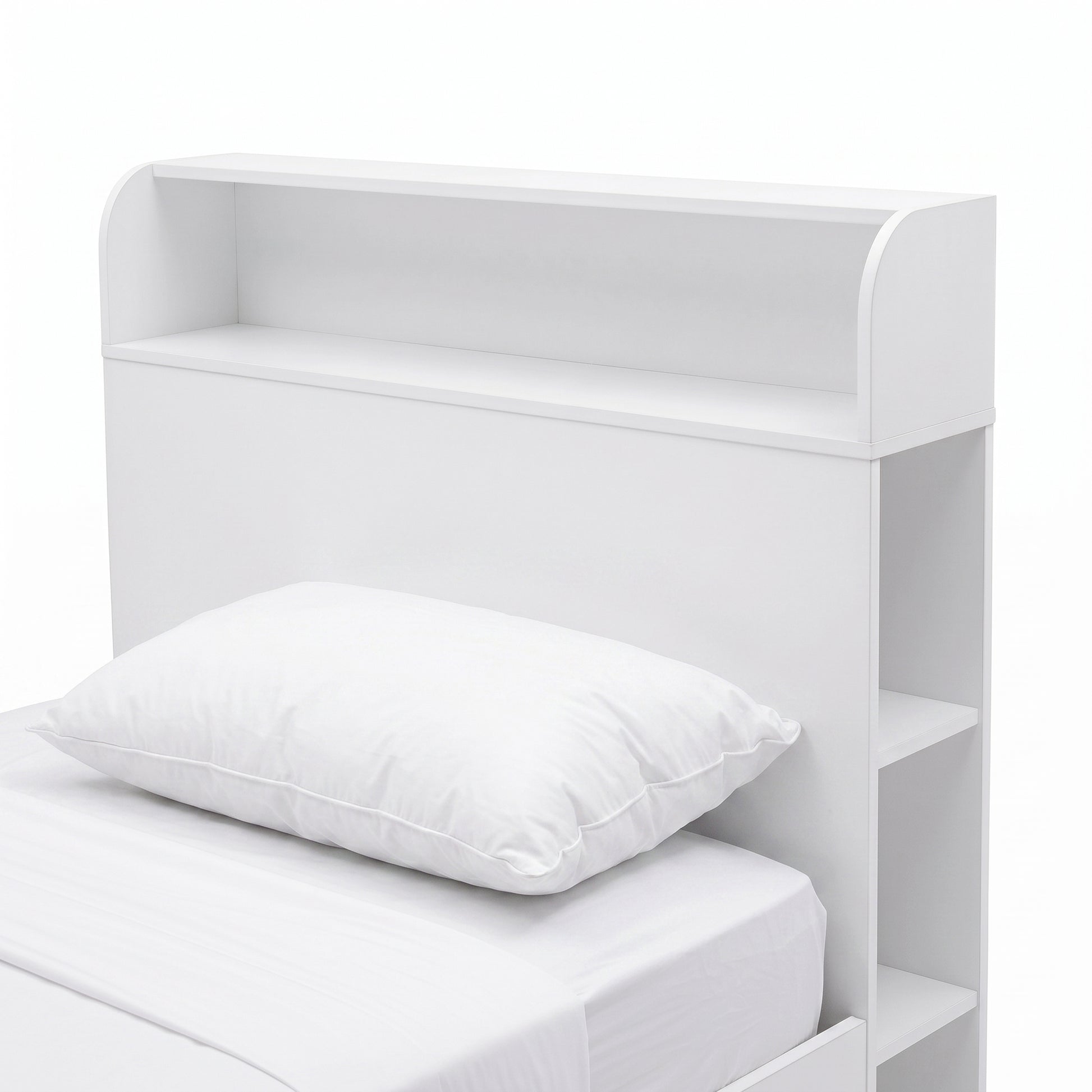 Close-up of the headboard and upper portion of a white bed with built-in shelving.