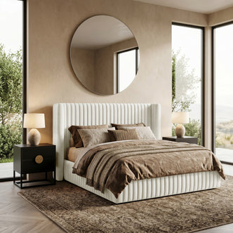 Upholstered bed in styled bedroom with nightstands and large windows