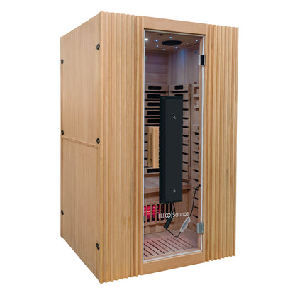Modern personal sauna on a white background with glass door and visible interior bench.