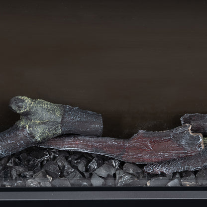 Close-up of logs and stones inside an electric fireplace in a home setting
