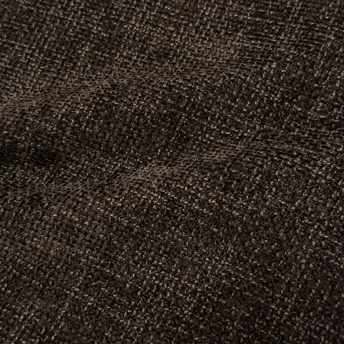 Close-up of cocoa brown woven upholstery fabric texture.