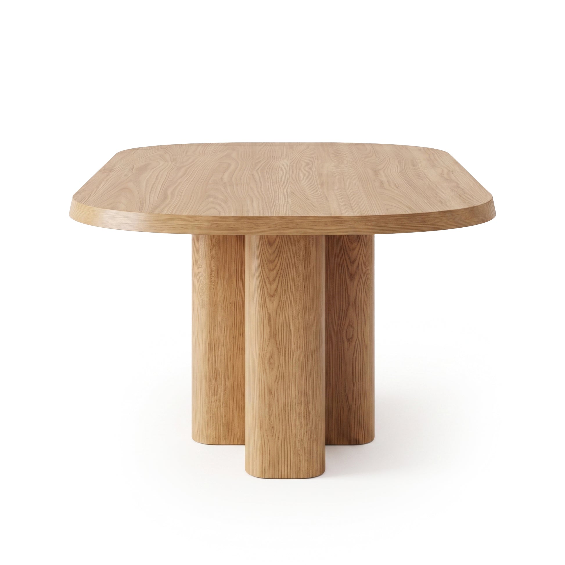 Wooden dining table with rounded rectangular top and three cylindrical legs on white background
