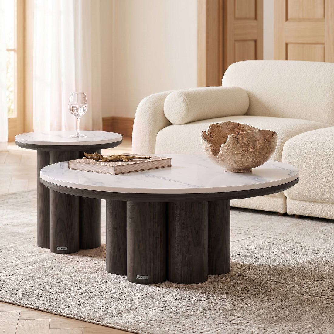 Two modern round coffee tables styled in a bright contemporary living room