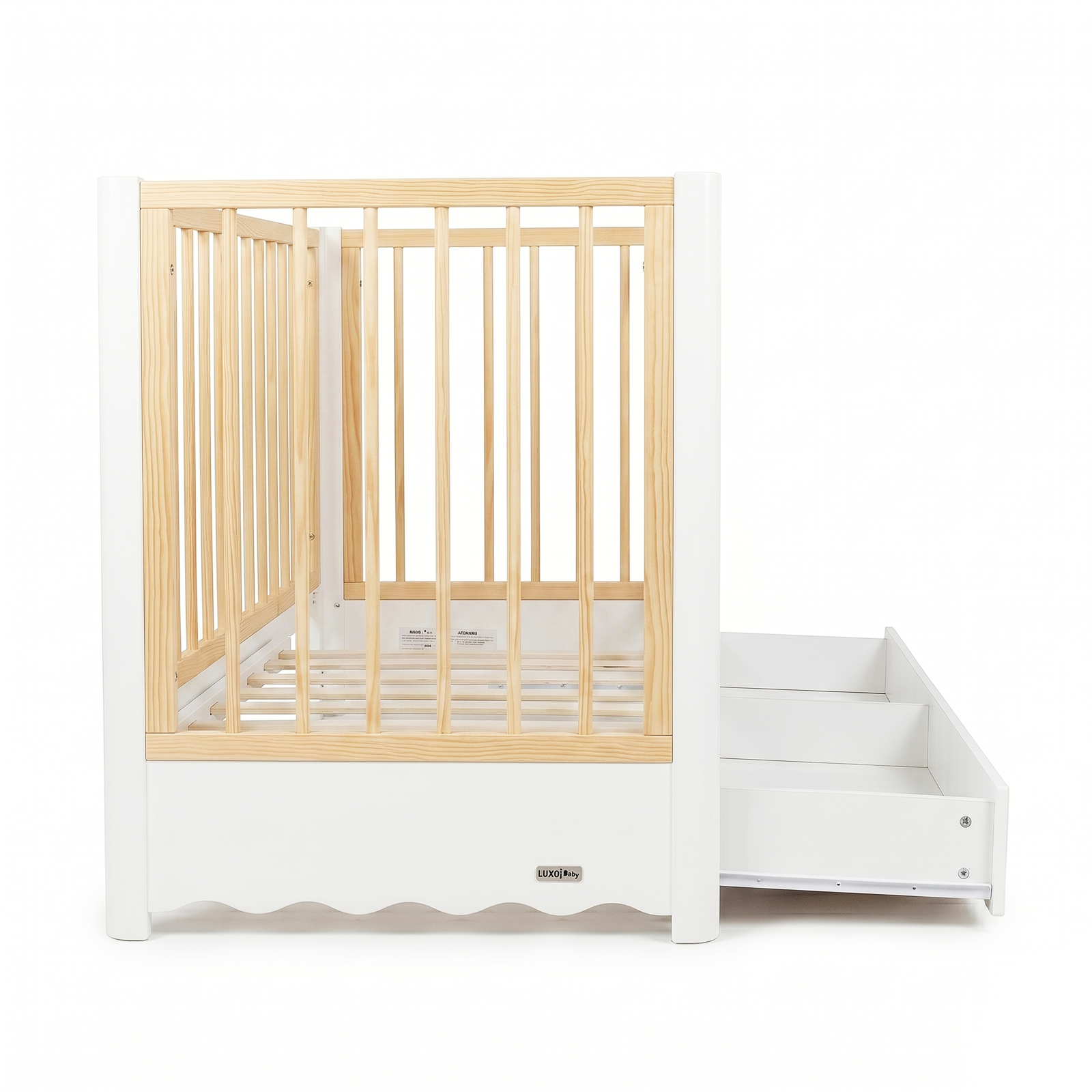 White and natural wood baby crib with pull-out storage feature on white background