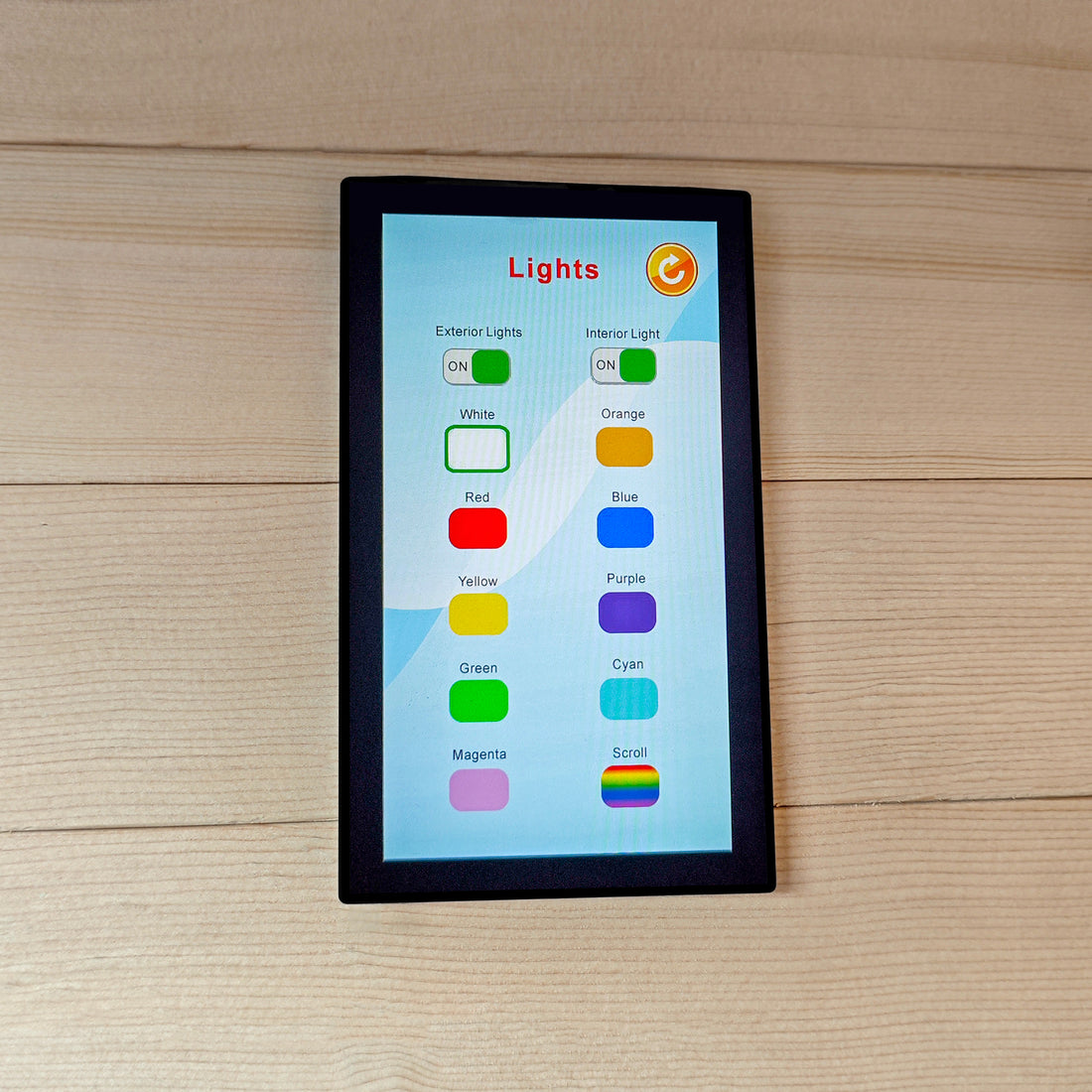 Touchscreen control panel with lighting controls mounted on wood.