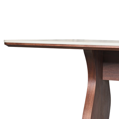 Close-up of a table corner with dark curved leg on white background