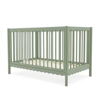 Sage green crib on white background
