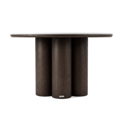 Dark wooden side table with round top and four cylindrical legs on a white background