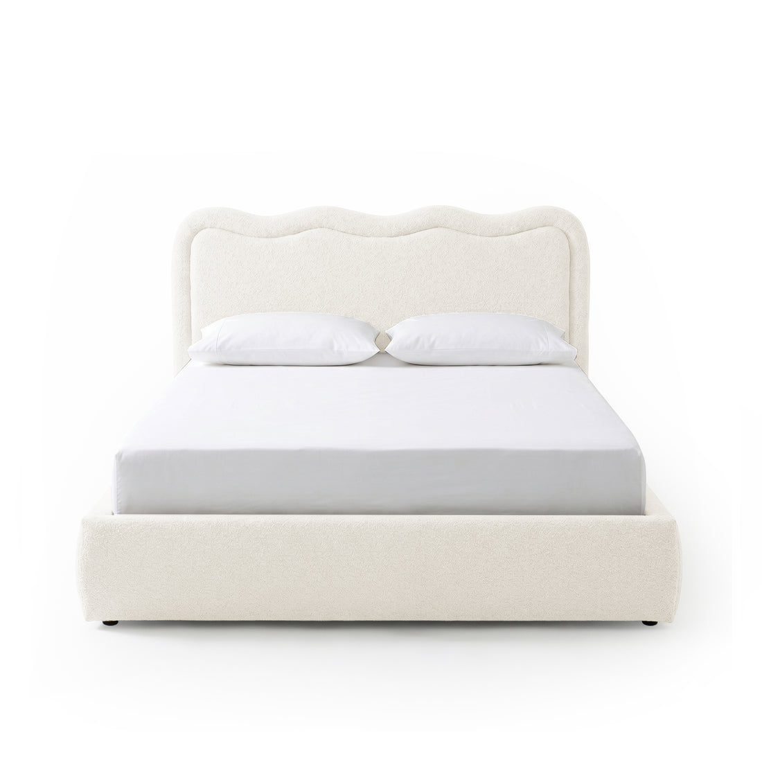 Modern upholstered bed with pillows on white background