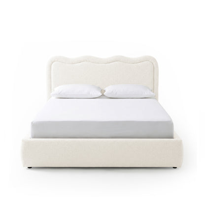 Modern upholstered bed with pillows on white background