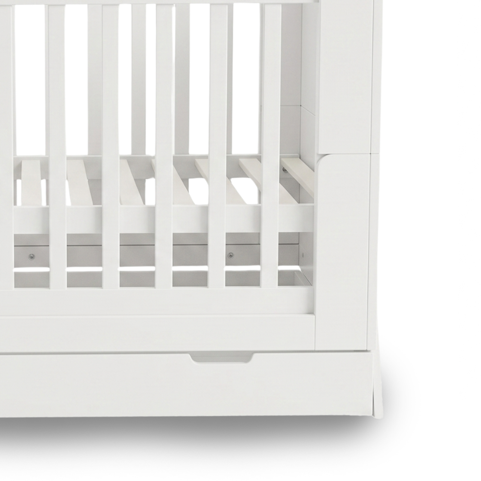 Detailed close-up of lower half of white crib slats and base