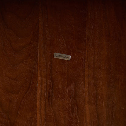 Close-up of polished wood surface with a metal brand label