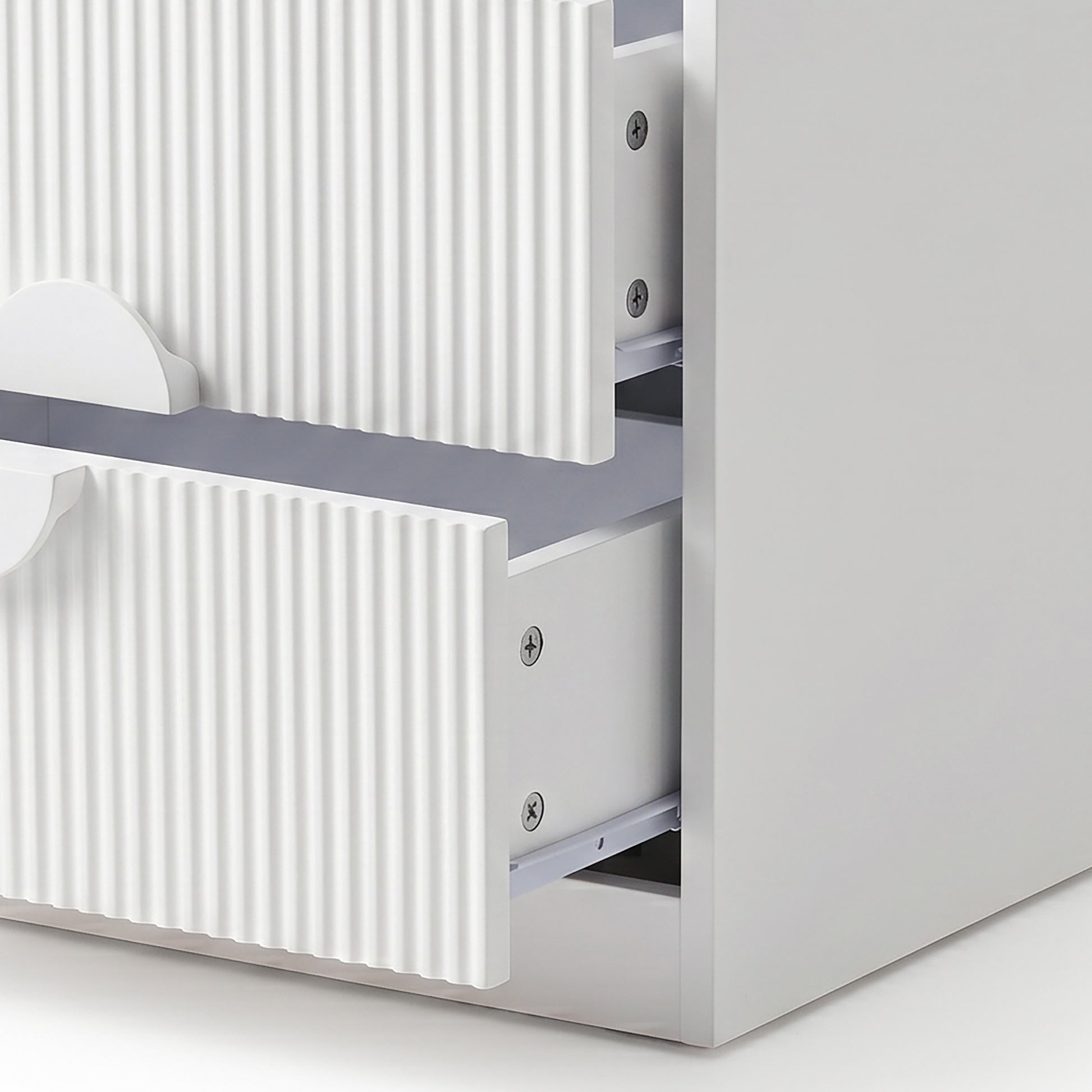 Close-up of open white drawers with visible hardware on white background