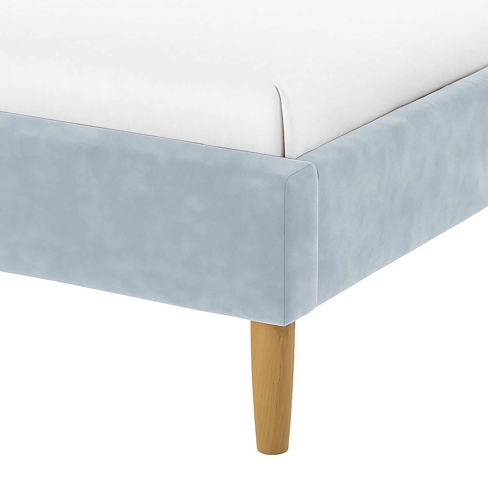 Close-up of the Estilla Velvet Rainbow Bed in Ice Blue, showcasing a pale-blue fabric-covered side rail and footboard, topped by a white mattress, all supported by a tapered wooden leg.