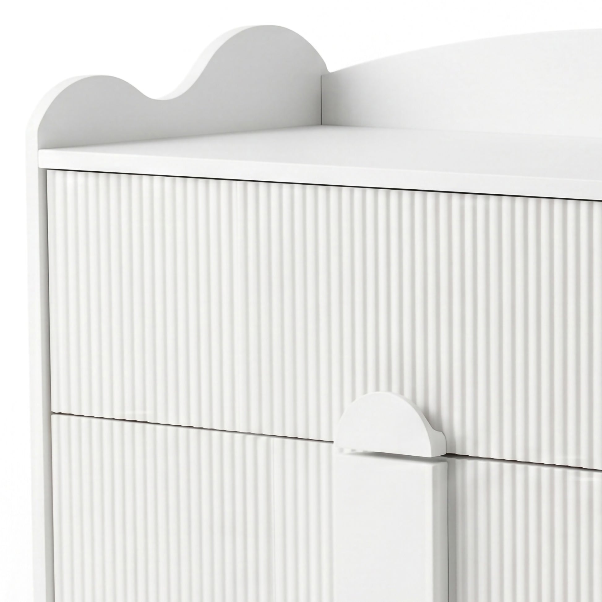 Upper section of white dresser with grooved texture and scalloped top edge