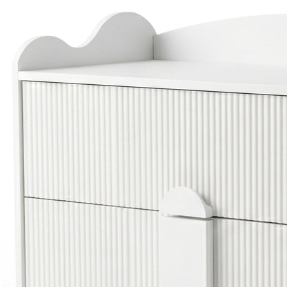 Upper section of white dresser with grooved texture and scalloped top edge