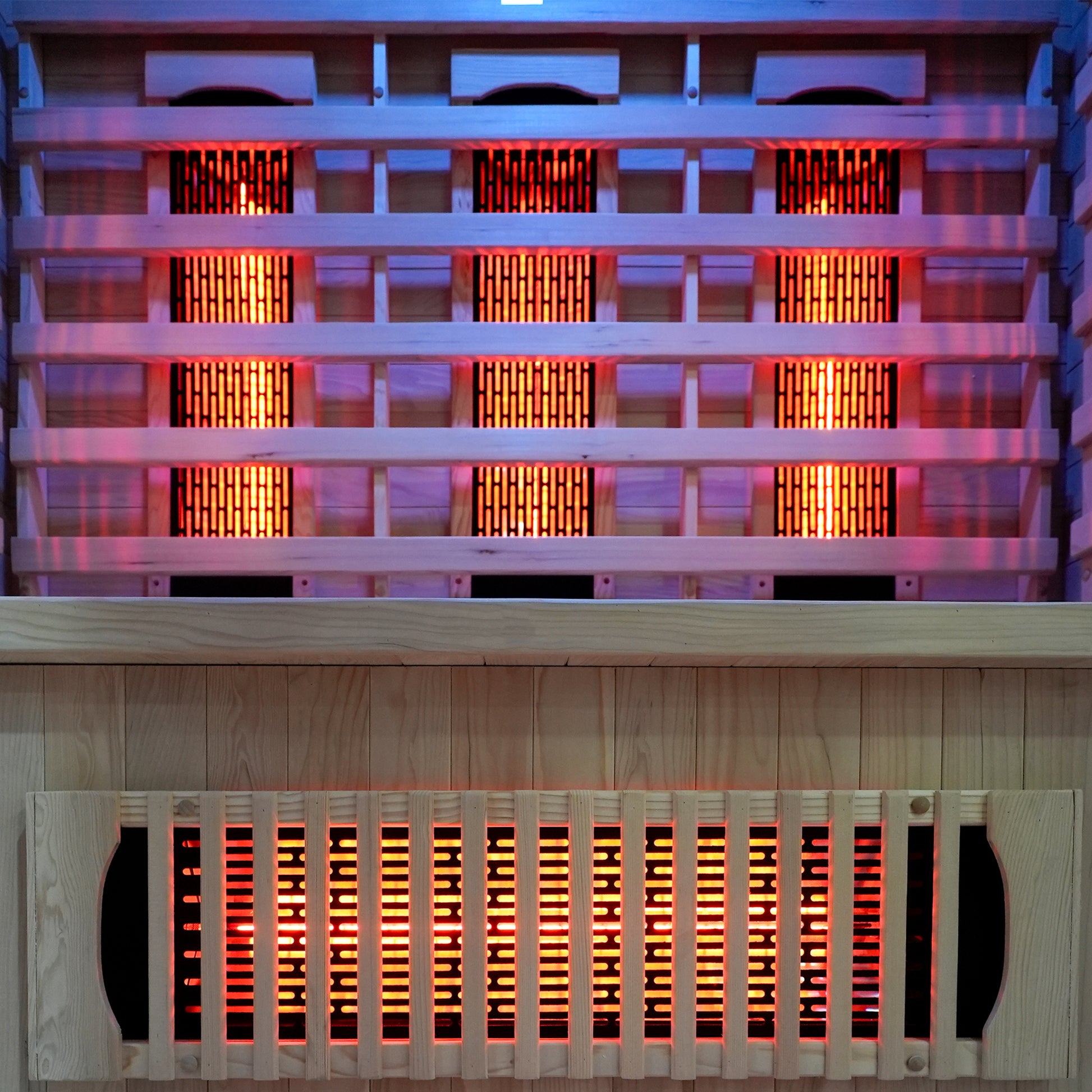 Close-up of glowing infrared heating elements inside a wooden sauna