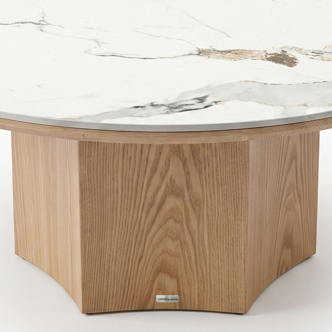 Close-up partial view of a round table with a marble-style top and light wood pedestal base on a white background.