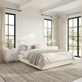 King bed in a bright, neutral-toned bedroom with nightstands and lamps