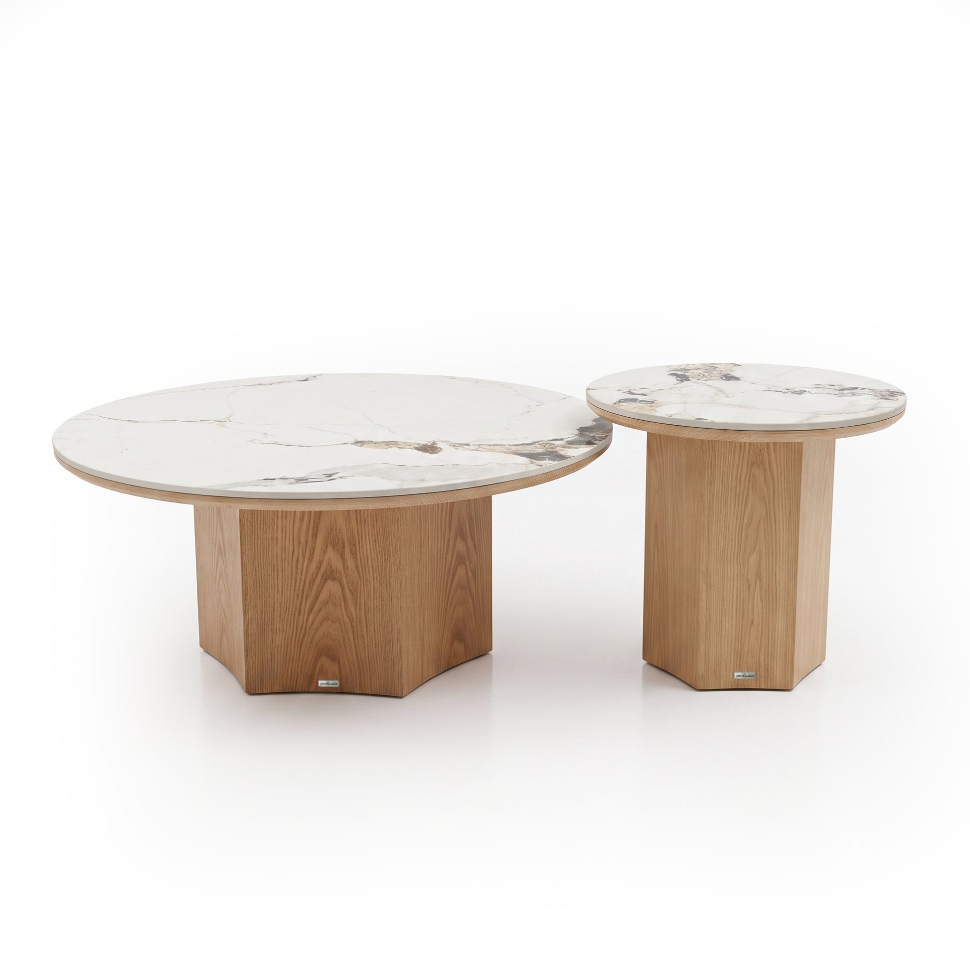 Set of two round nesting tables with marble tops and geometric wood bases on a white background.