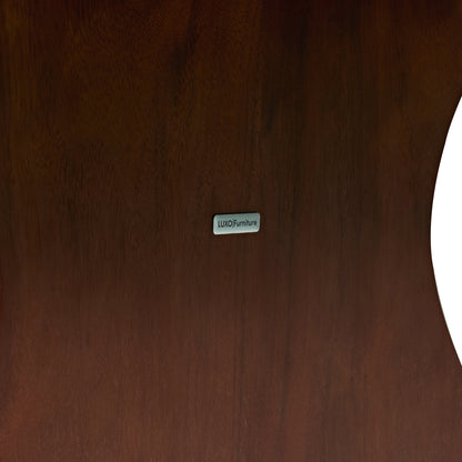 Close-up of dark wood surface with LUXO Furniture label