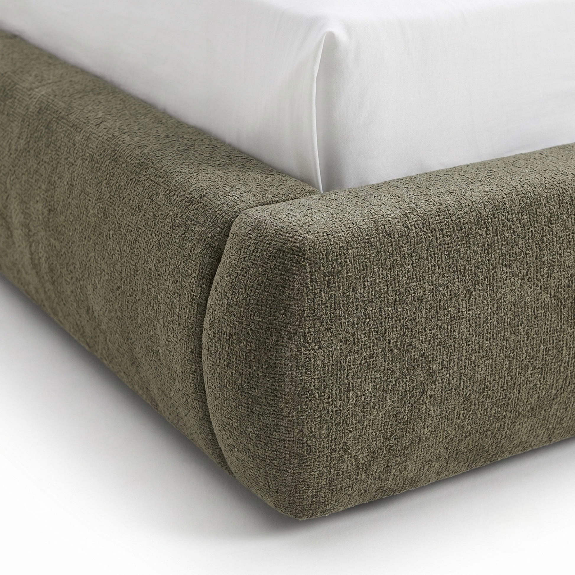 Close-up of upholstered bed frame corner with textured fabric